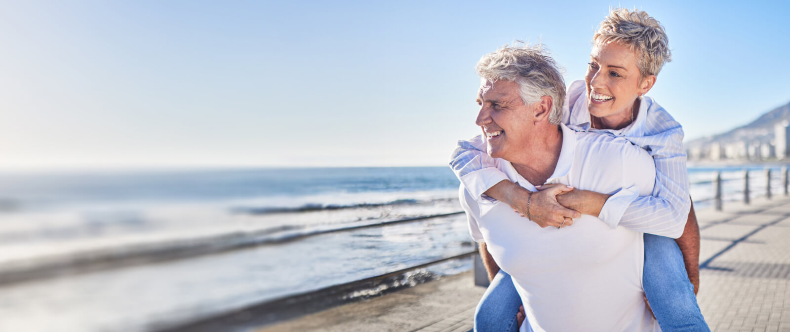 man and woman walking together on a beach