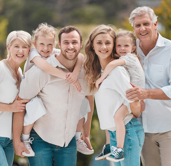 multigenerational family standing together and smiling