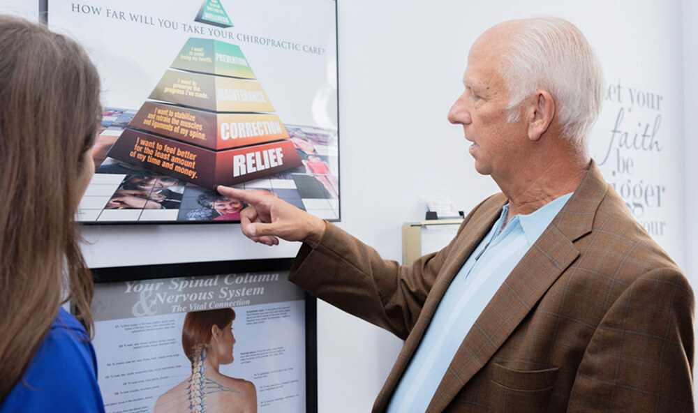 Mobile chiropractor in discussion with a patient
