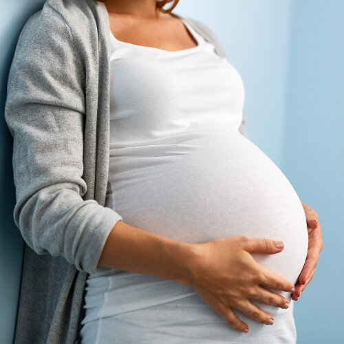 Pregnant woman holding her stomach