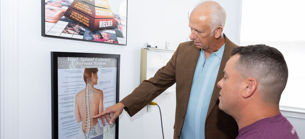 Mobile chiropractor in discussion with a patient