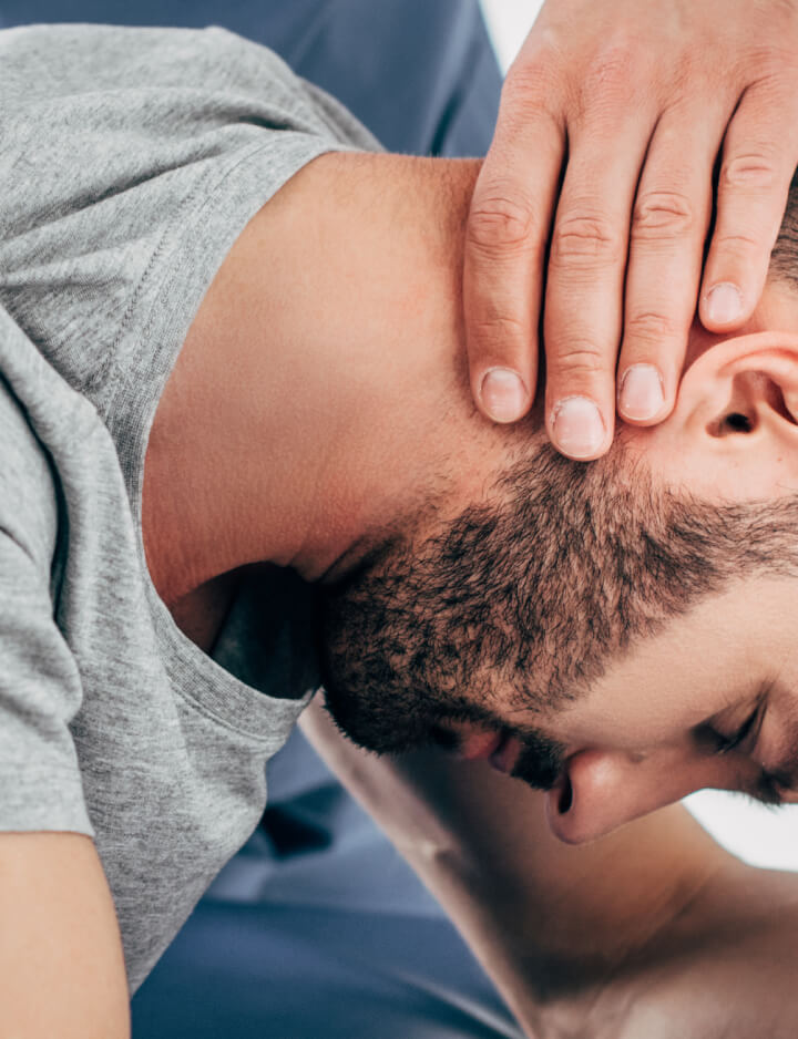 Female patient receiving chiropractic treatment for her neck