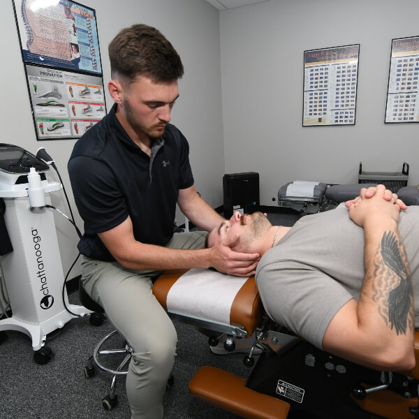 Chiropractor treating patient's neck
