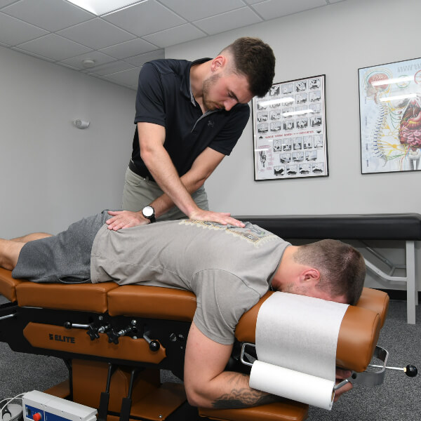 Male patient receiving a chiropractic adjustment