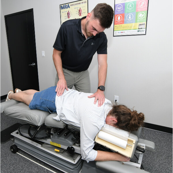 Female patient receiving adjustment from a chiropractor