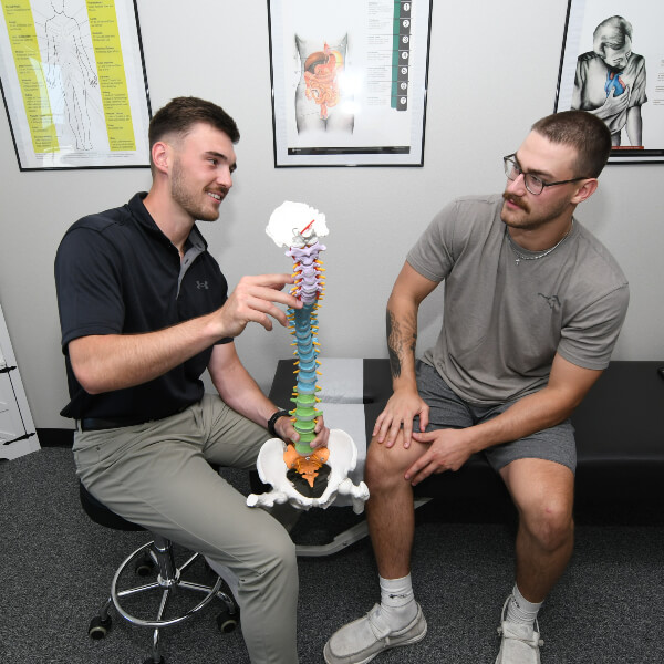 Chiropractor in discussion with patient