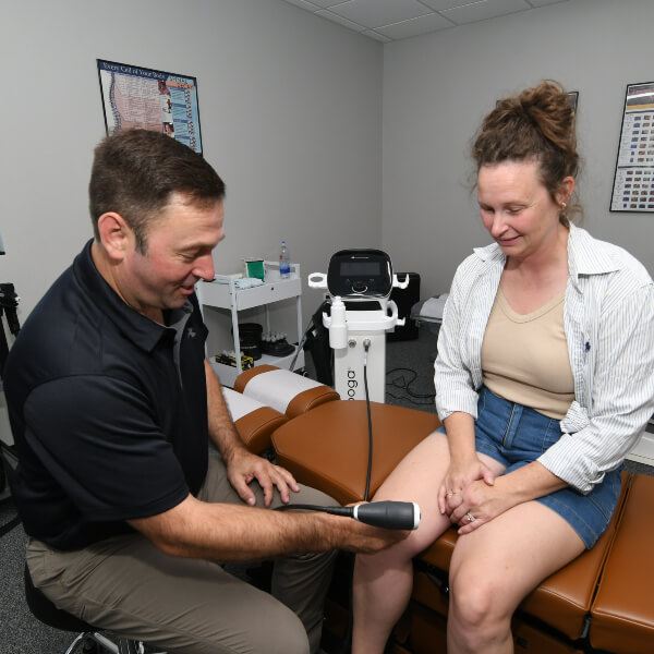 Gilbert Chiropractor treating patient's knee with Shockwave Therapy