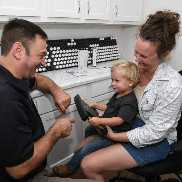 Chiropractor in consultation with mom and baby