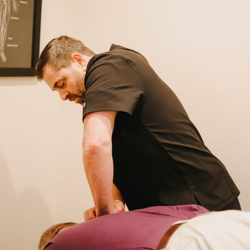 Dr Michael adjusting patients back