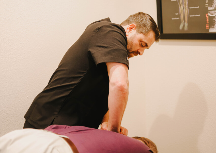 Allen chiropractor Dr Michael adjusting patients upper back