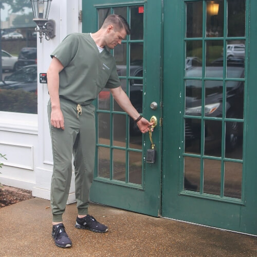 Chiropractor opening the office front door
