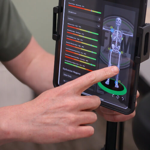 Chiropractor pointing to knee area on x-ray