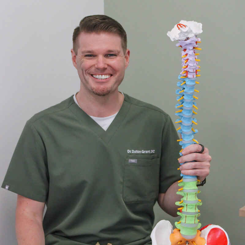 Dr. Dalton holding spine model