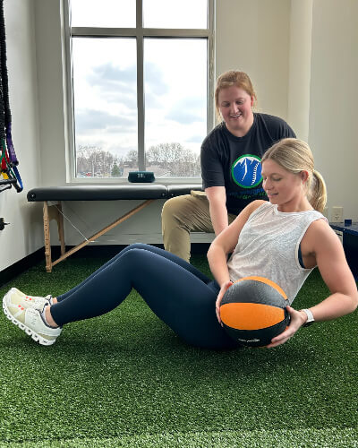 Woman using medicine ball