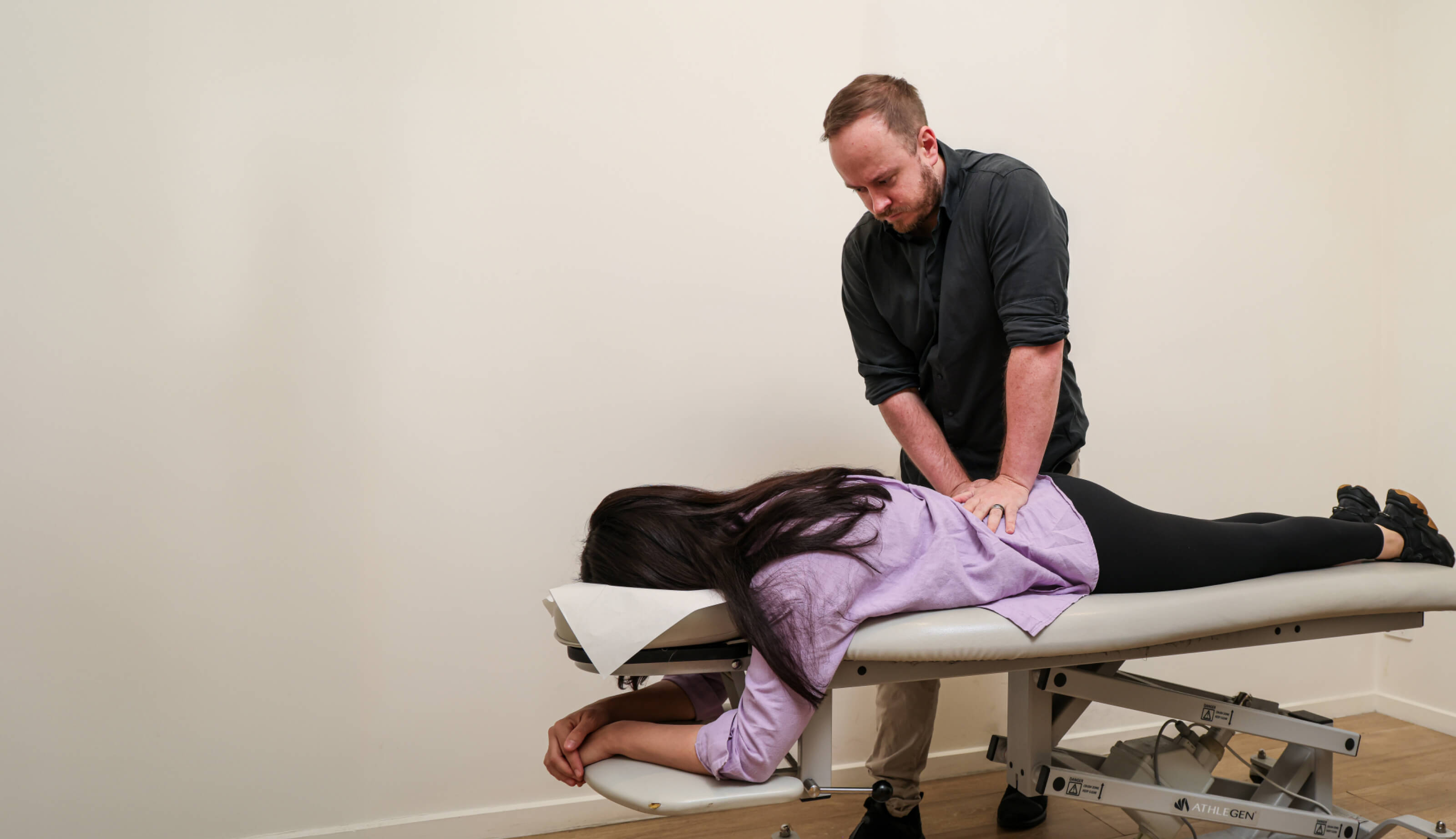 Chiropractor adjusting patient's back