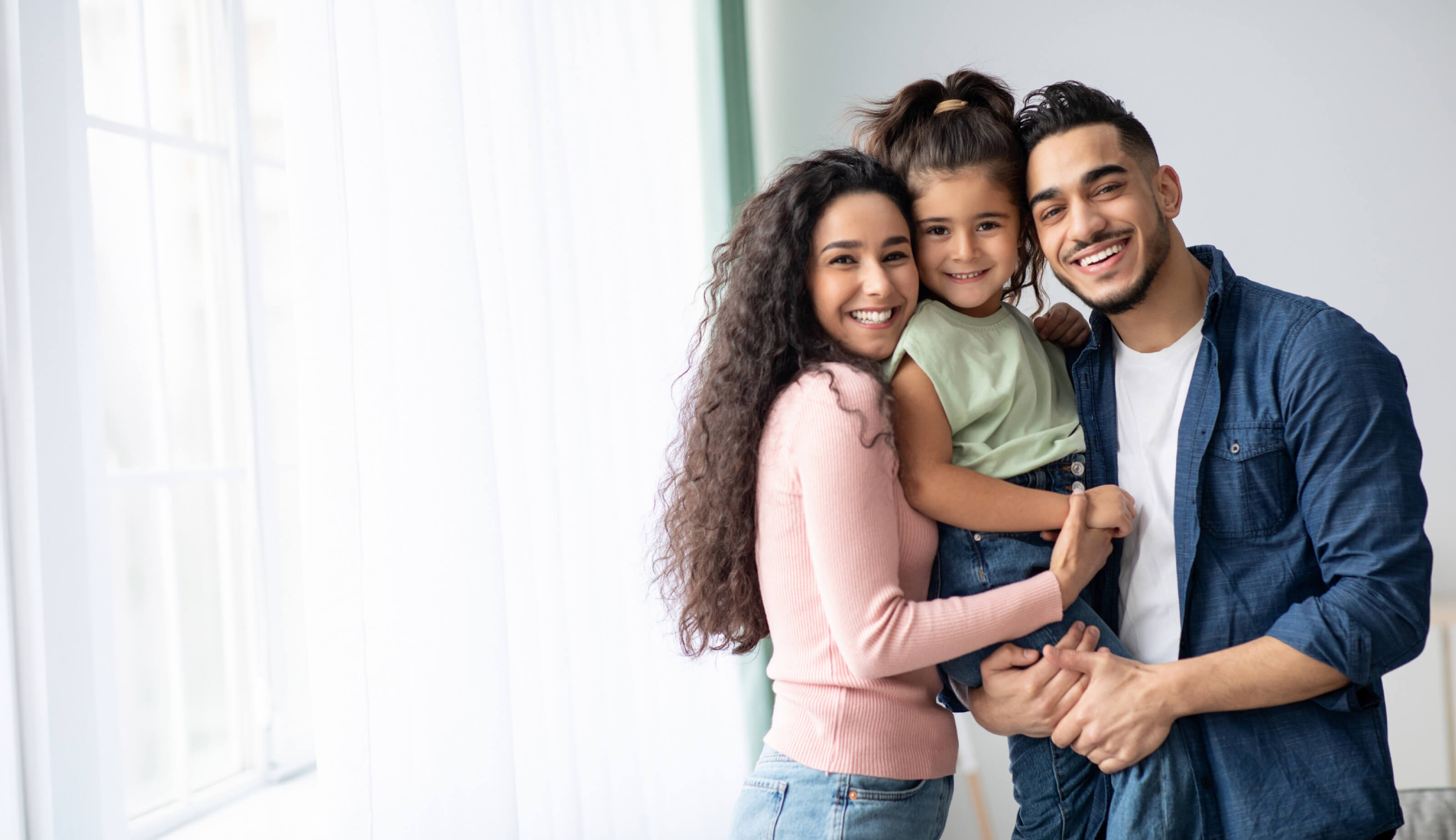 Smiling family of three