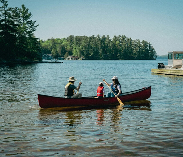 mom and kids canoeing on a lake