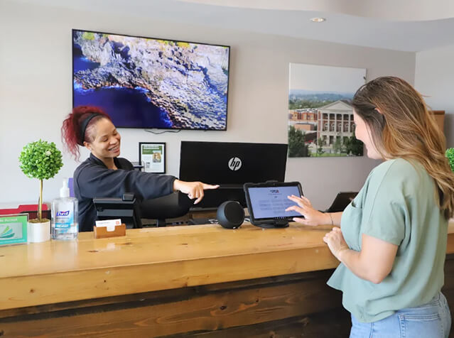 Spine Stop Chiropractic patient checking in at front desk