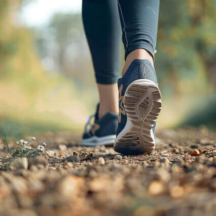 person in tennis shoes walking outdoors