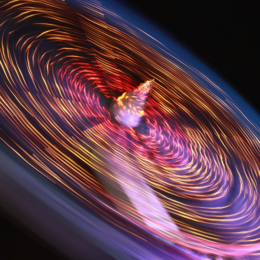 Colorful spinning lights create dynamic movement in this vibrant abstract image.