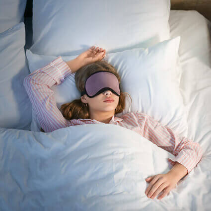 woman sleeping sprawled with eyemask