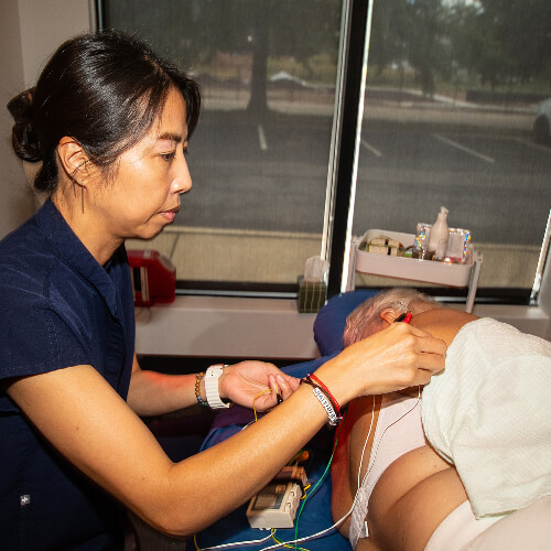 Acupuncturist treating patient
