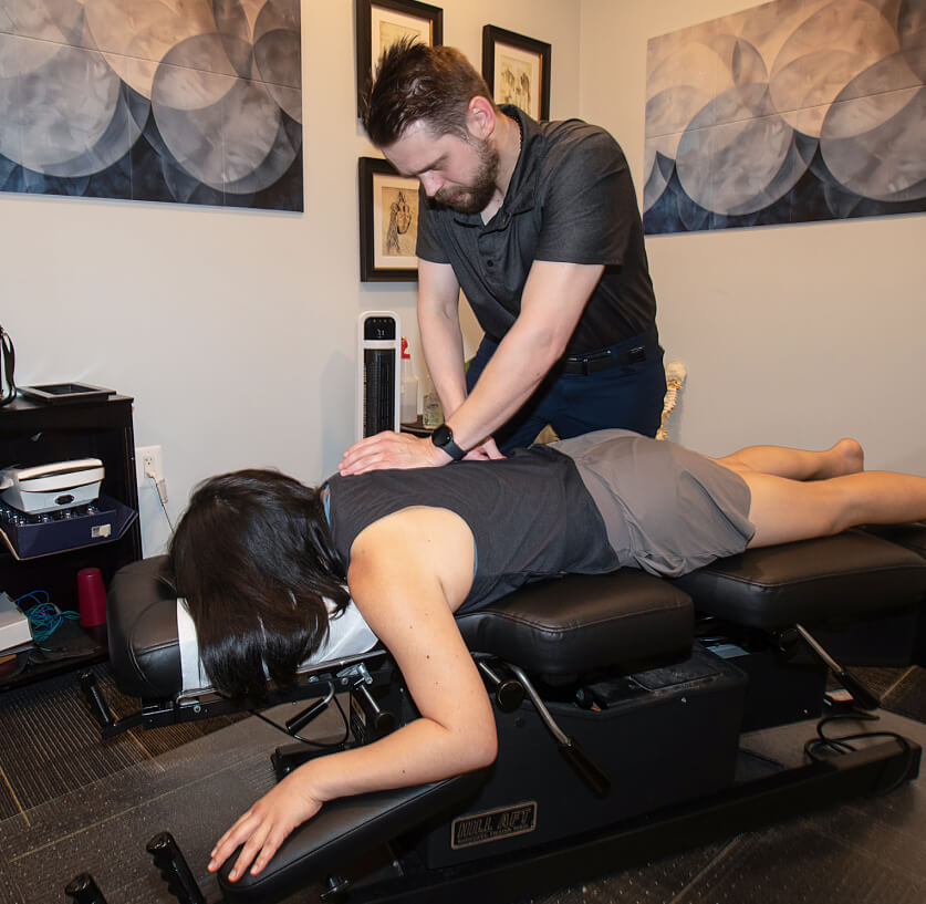 Chiropractor adjusting patient