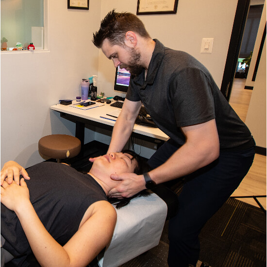 Female patient receiving a chiropractic adjustment