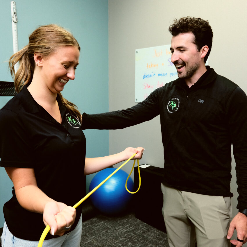 chiropractor showing patient how to do an exercise