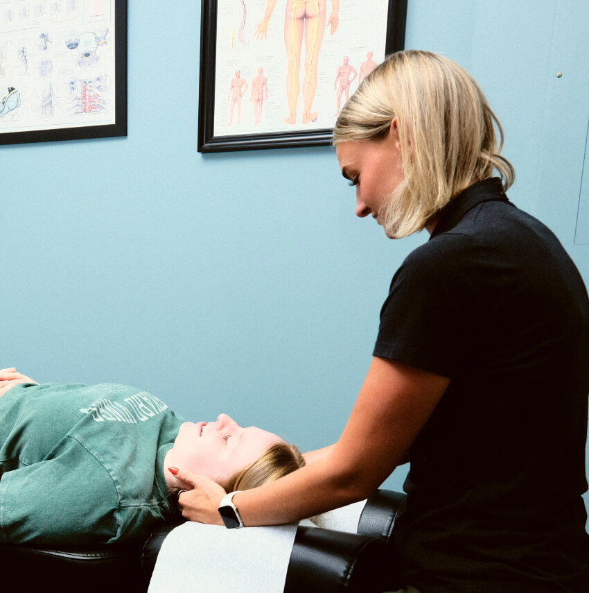 chiropractor adjusting patients neck