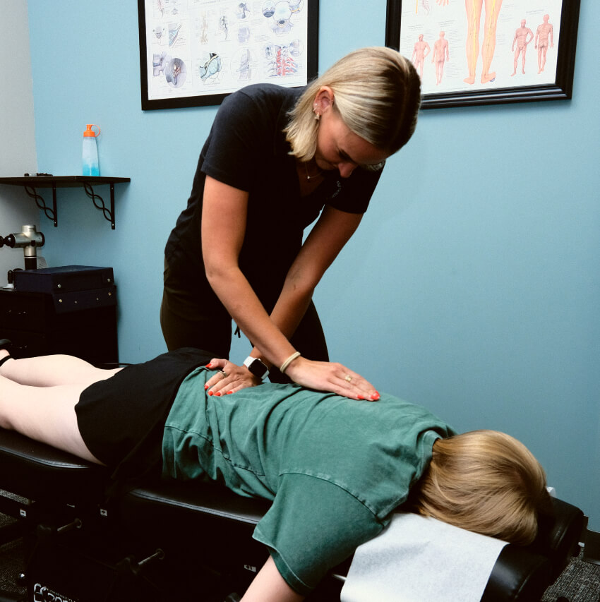 chiropractor adjusting patients lower back