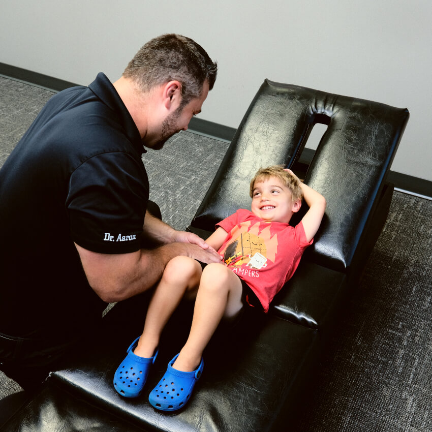 kid laying on an adjusting table