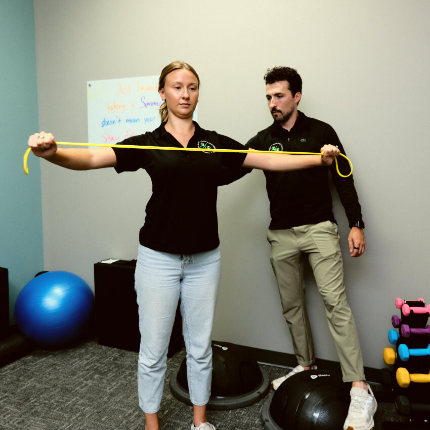 chiropractor showing patient how to do an exercise