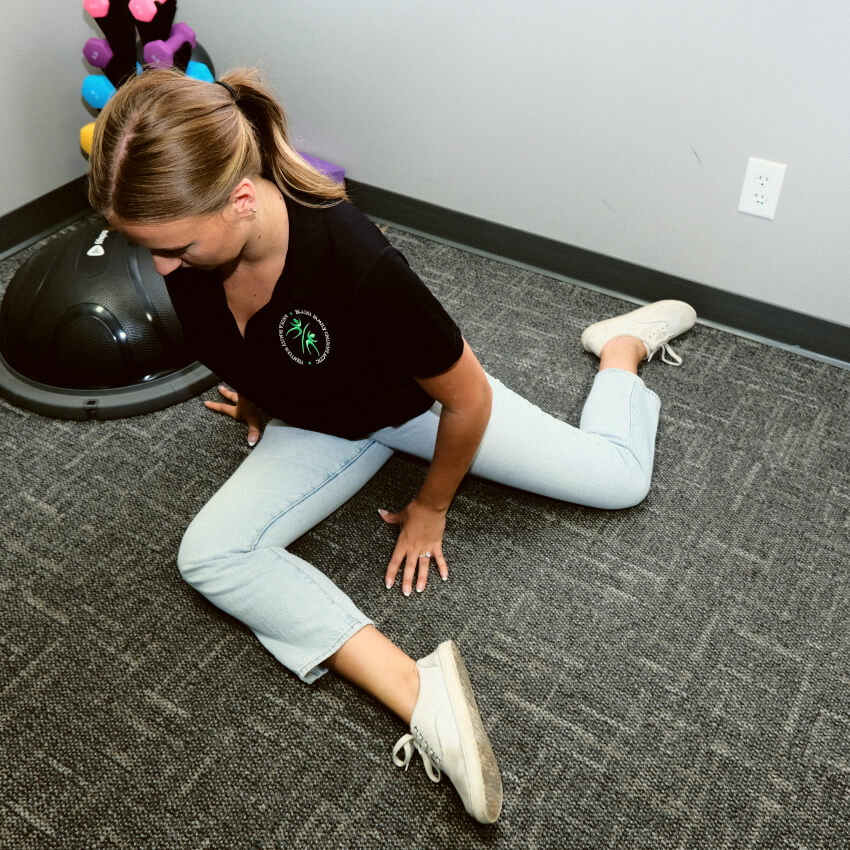 patient stretching legs on the floor