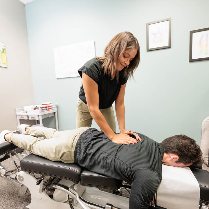 Anoka chiropractor adjusting patients back