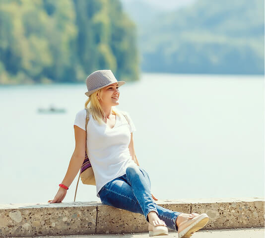 Woman sitting outdoors smiling