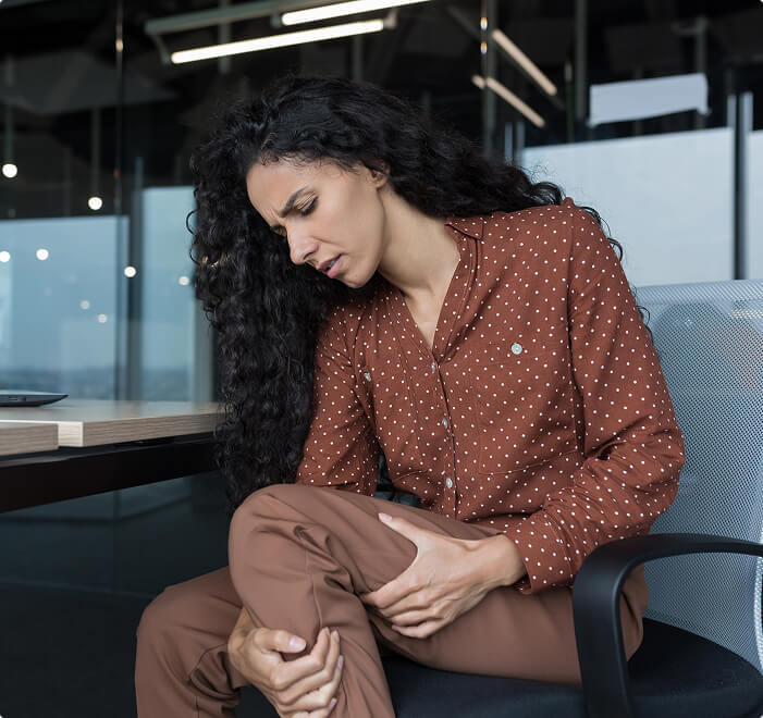 woman holding painful legs