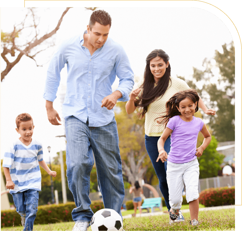mom dad and 2 kids playing soccer together
