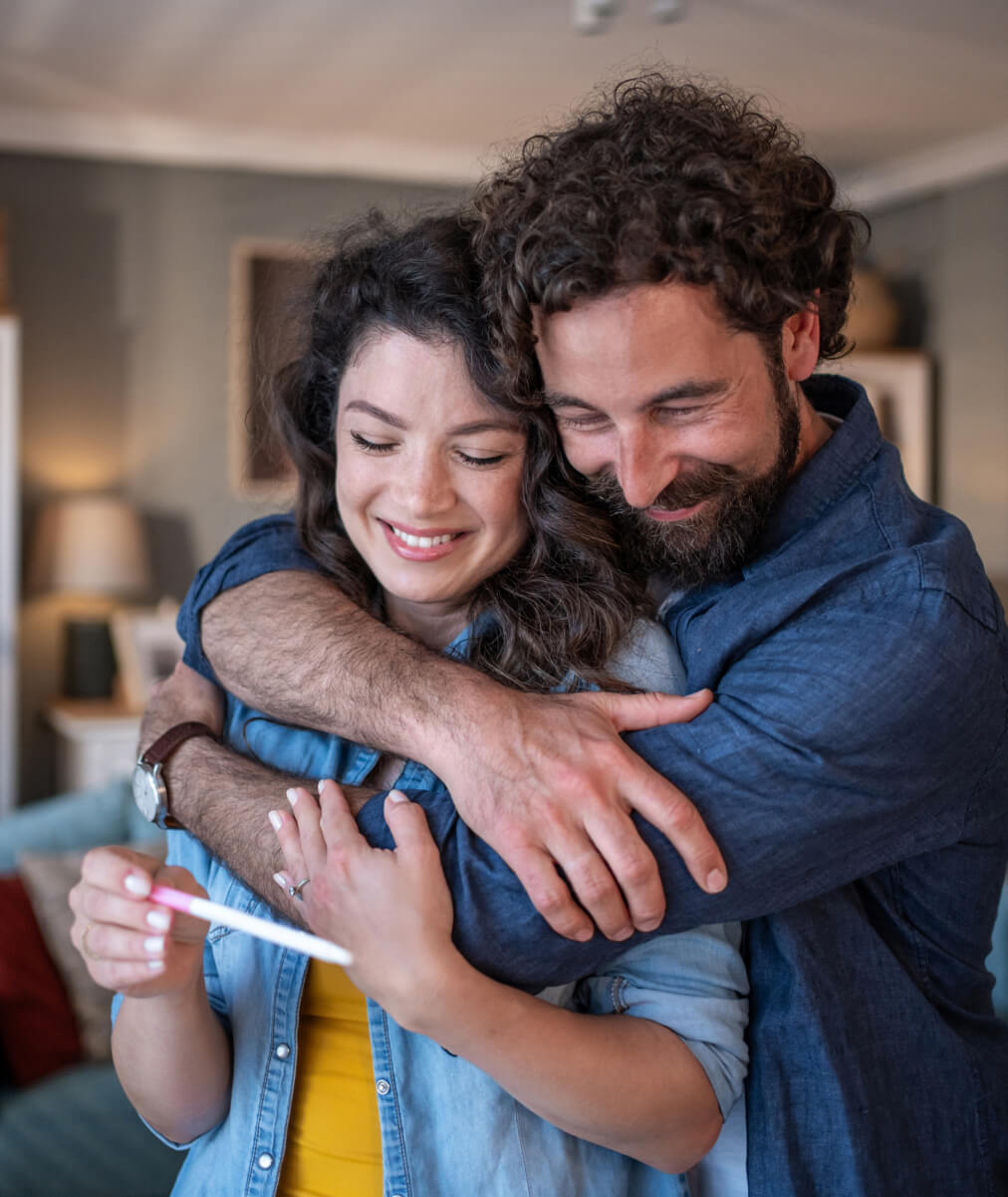 man and woman hugging and smiling