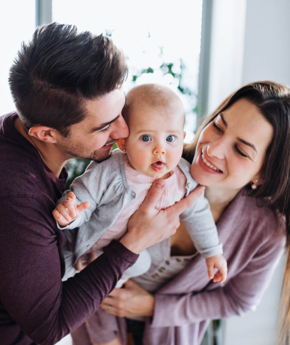 mom and dad holding little baby