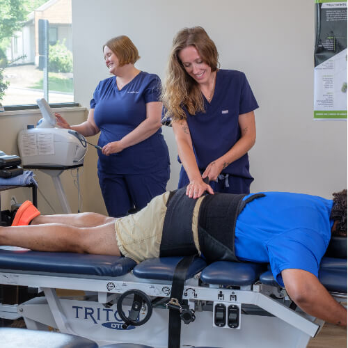 Male patient receiving a chiropractic adjustment