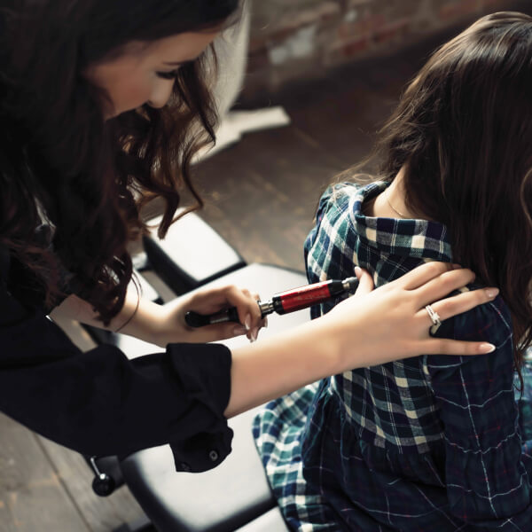 Chiropractor using activator method to treat a McAlester patient 