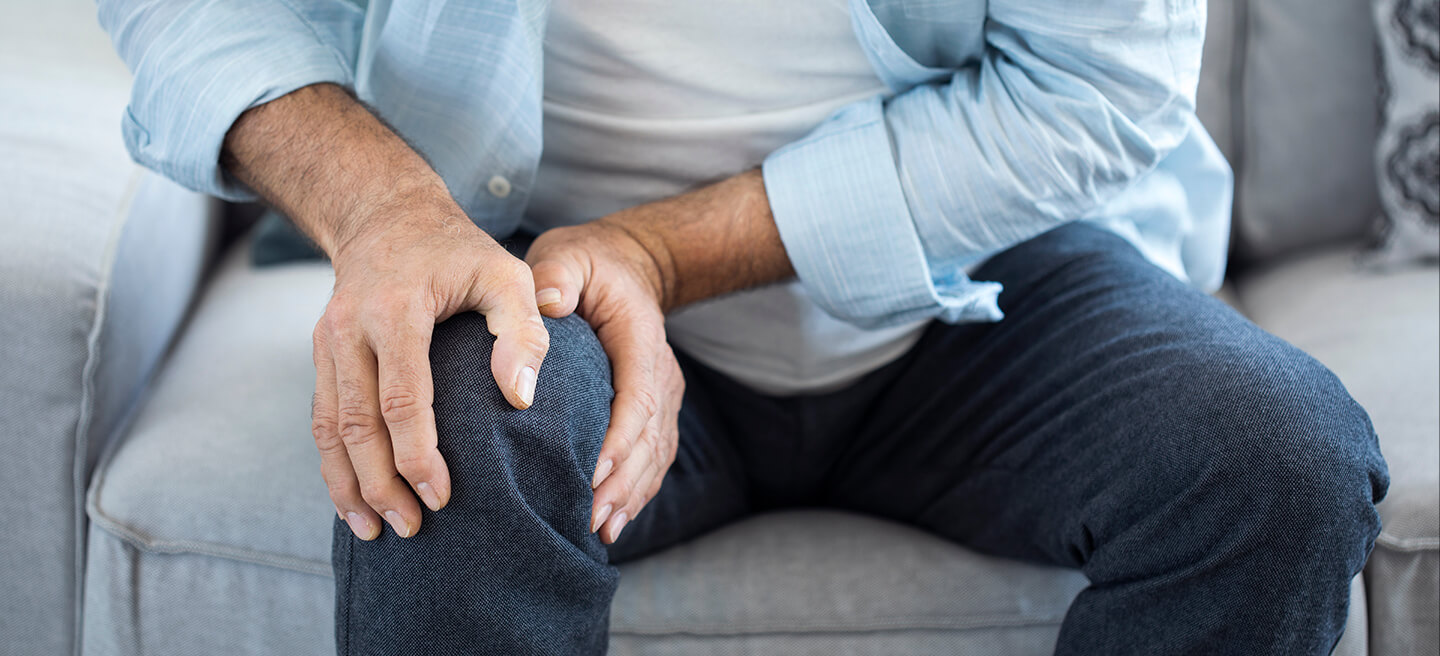 man holding knee with Knee Pain