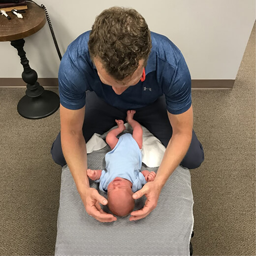 Dr Curt adjusting baby