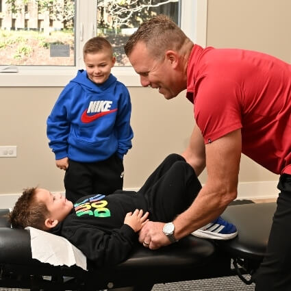 Two young boys and a chiropractor
