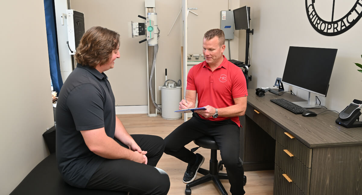 South Elgin chiropractor in consultation with a patient