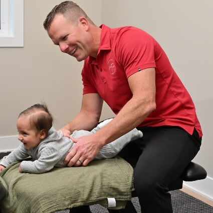 Chiropractor adjusting a baby
