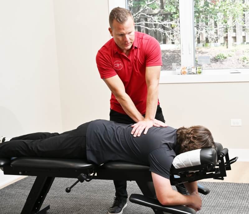 South Elgin chiropractor Dr. Curt Buss adjusting a patient's back