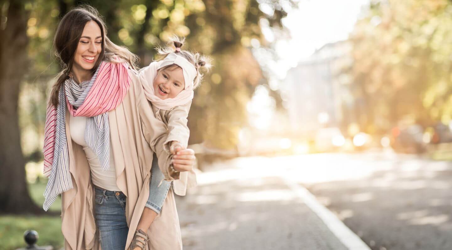 young girl on mother's back