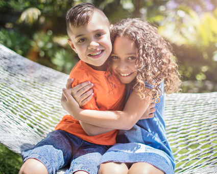 Happy brother and sister hugging each other